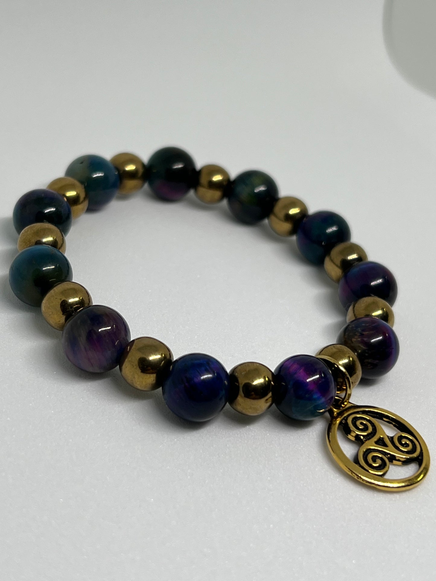 Galaxy Tiger’s Eye and Gold Plated Hematite with a Triskelion Gold Tone Charm