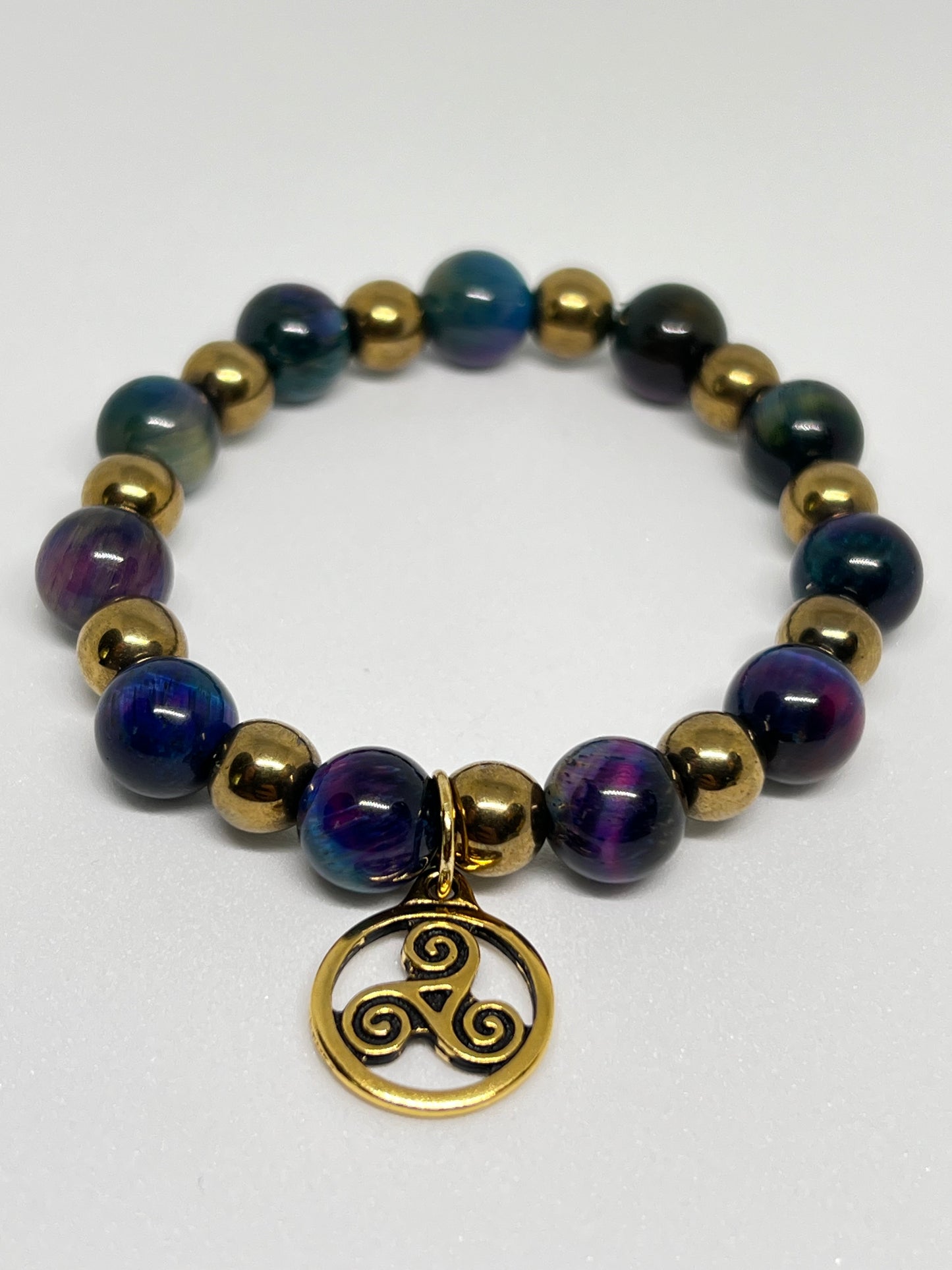 Galaxy Tiger’s Eye and Gold Plated Hematite with a Triskelion Gold Tone Charm