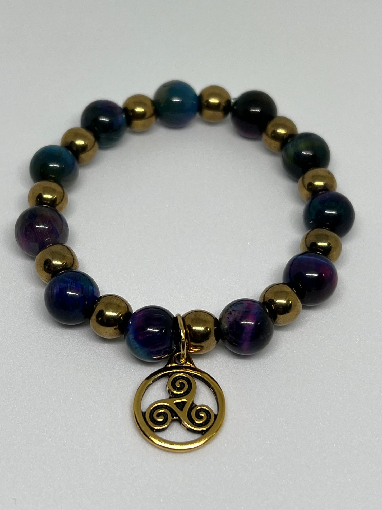 Galaxy Tiger’s Eye and Gold Plated Hematite with a Triskelion Gold Tone Charm