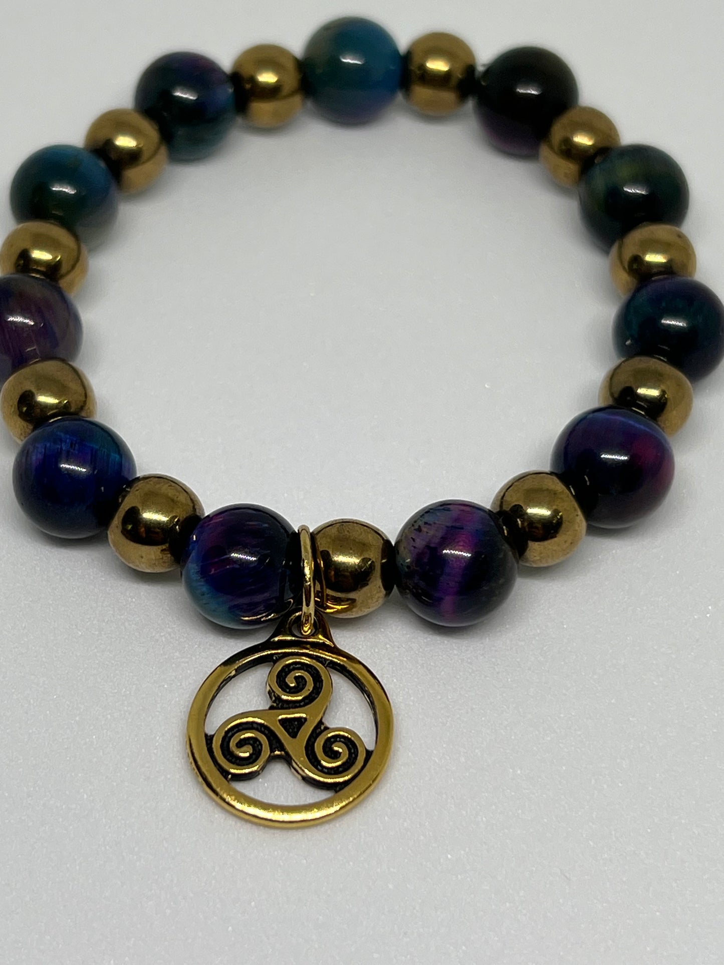 Galaxy Tiger’s Eye and Gold Plated Hematite with a Triskelion Gold Tone Charm